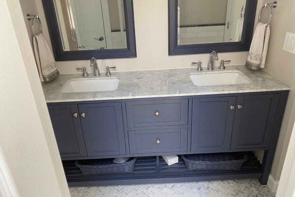 1 Elegant bathroom vanity with dual sinks and large mirrors.