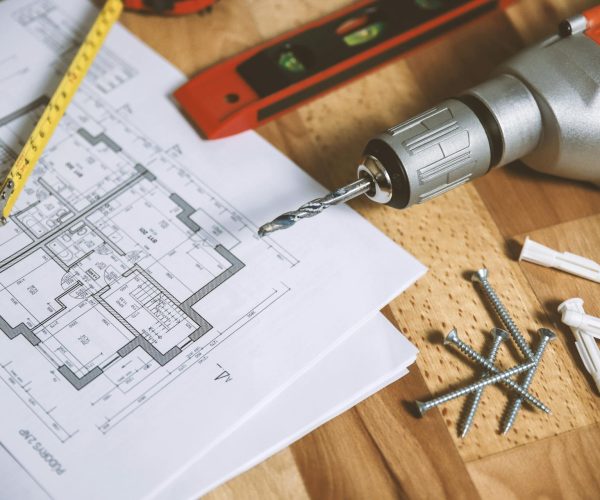 pexels-jeshoots-com-147458-834892 Construction plans with tools, screws, and measuring tape.