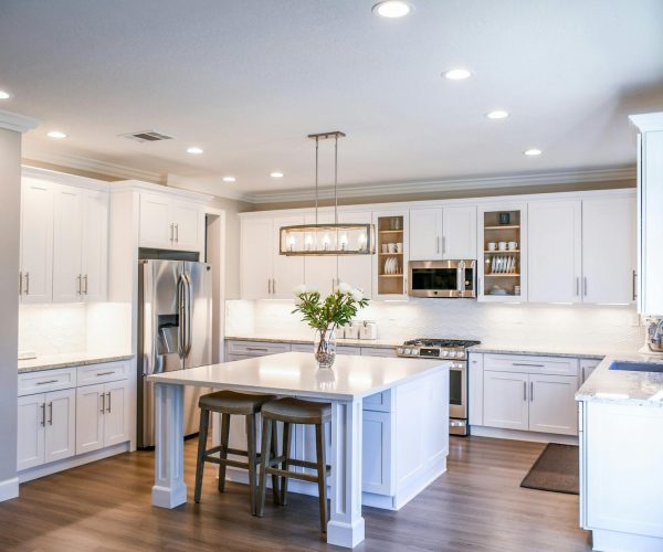 pexels-timesaverhacks-2724748 Elegant modern kitchen with white cabinets and center island.